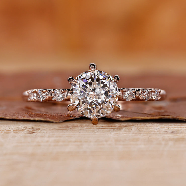 Pave Setting Ring with round cut side stone in rose gold.