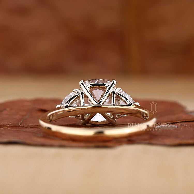 Yellow gold ring with three stone engagement ring diamond detail