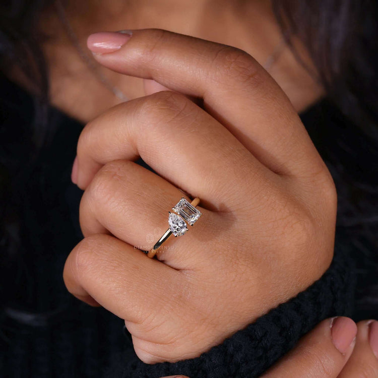 Unique two stone diamond ring showcasing an emerald cut diamond and a pear cut diamond in a UK engagement ring style.