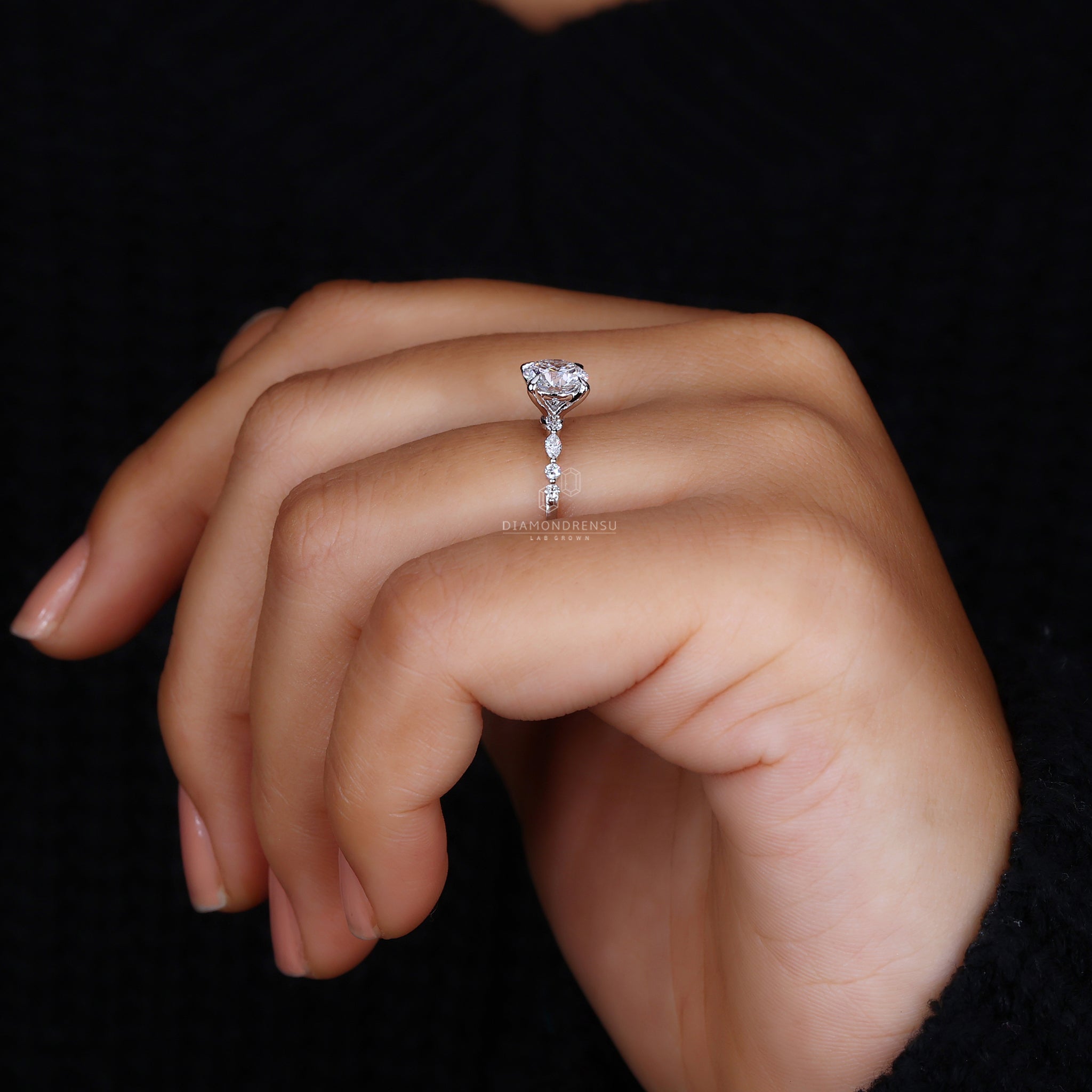 Marquise side diamond with round center.