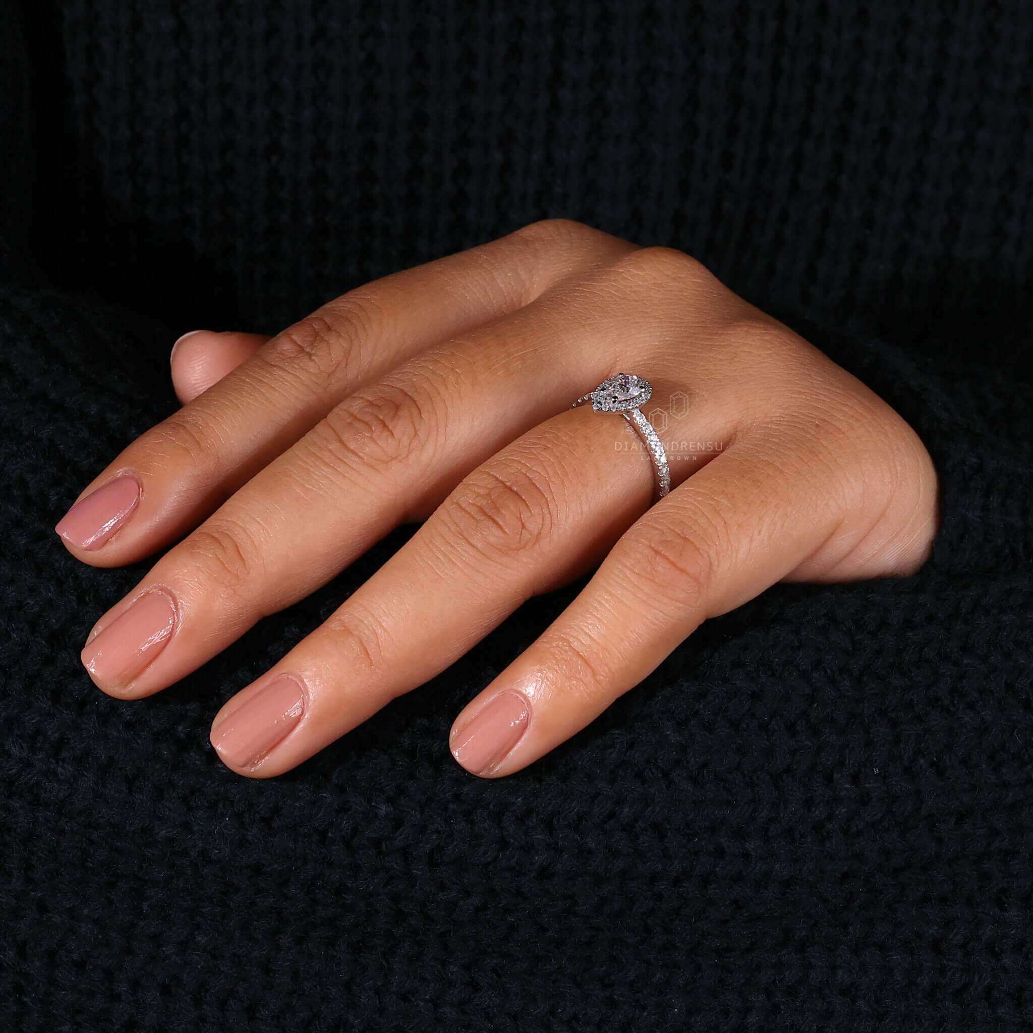 Teardrop ring crafted with pave ring diamond accents, perfect as a unique engagement ring for women.
