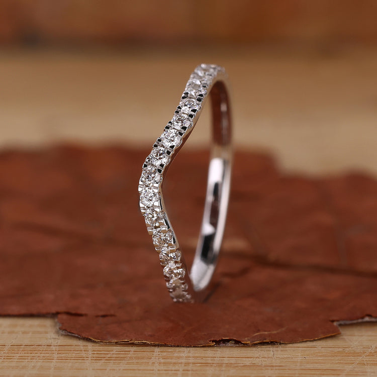 Curved wedding ring with round diamonds.