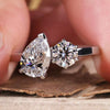 Gold engagement ring with a cushion cut diamond in a 4 prong claw setting for a timeless and elegant design.