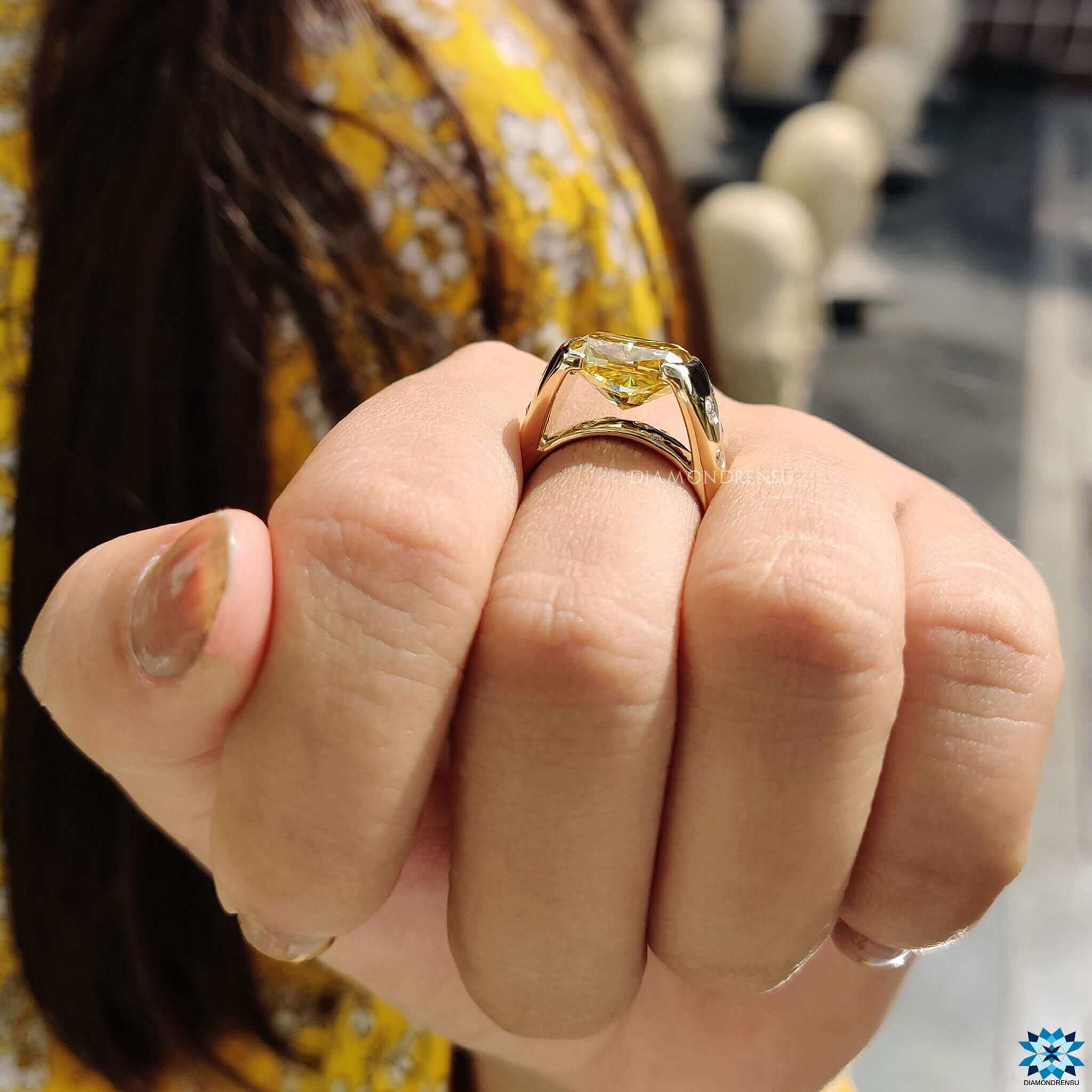 Cushion moissanite ring in a modern tension set with cathedral band.