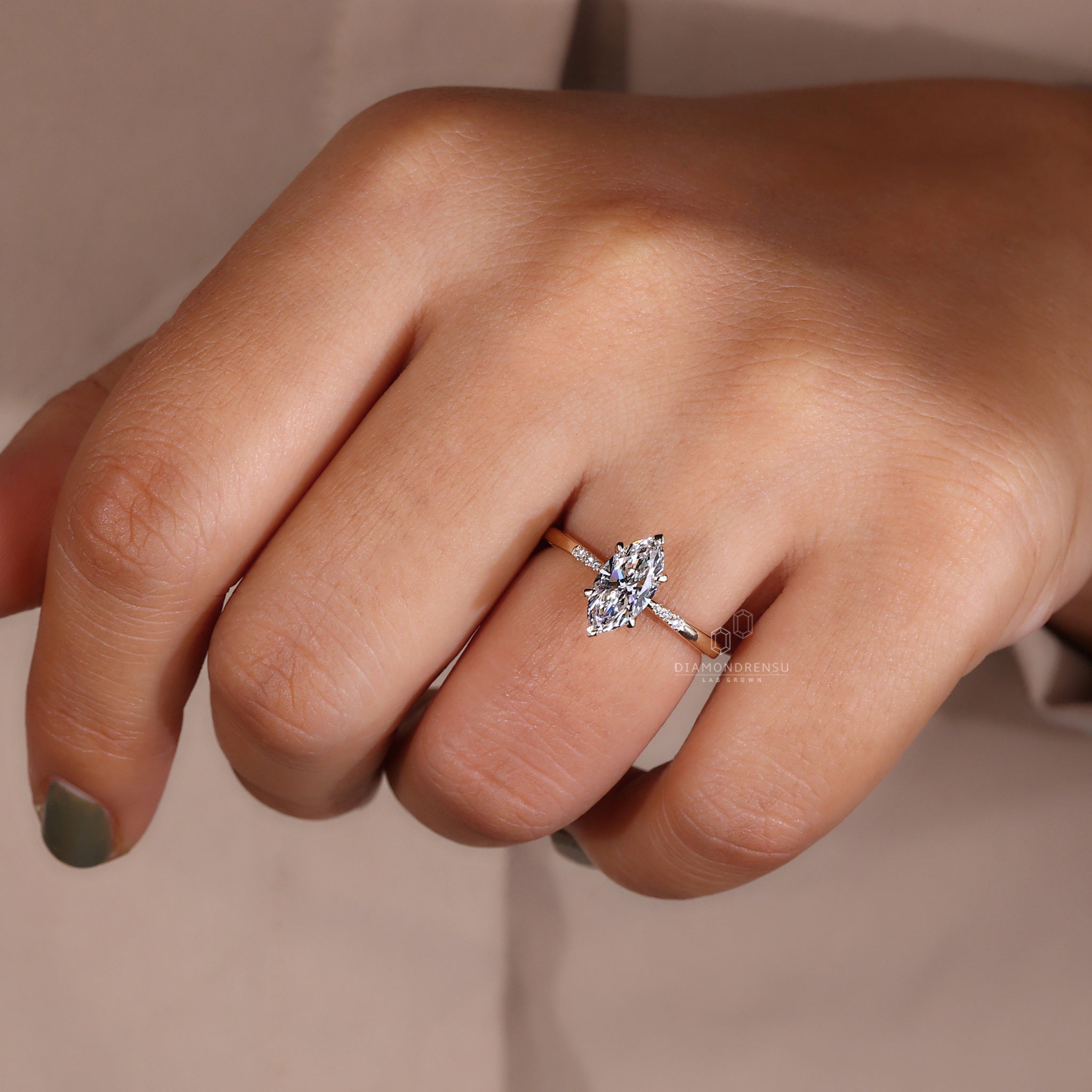 Yellow gold ring with a marquise diamond centrepiece.
