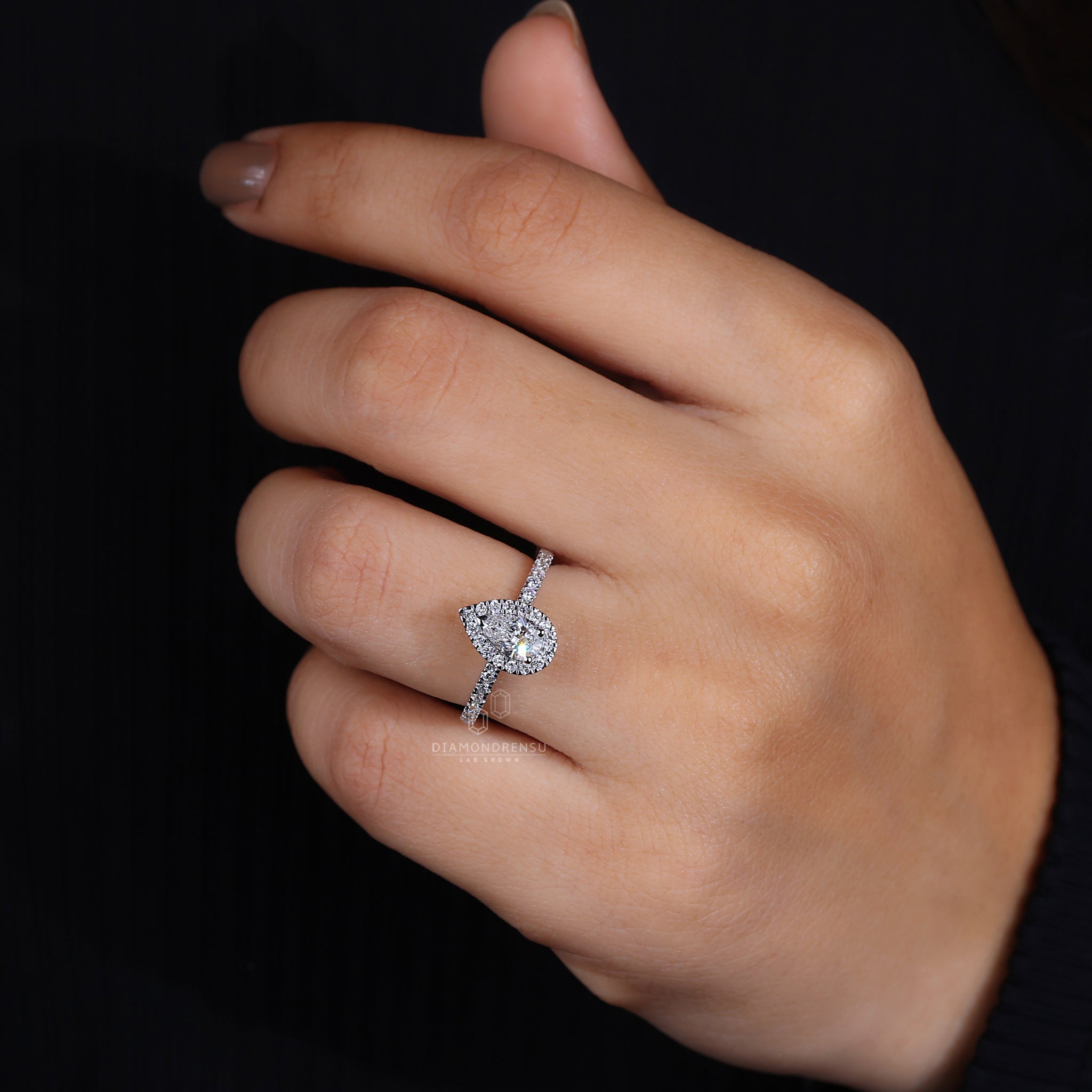 Pear ring with halo engagement style.
