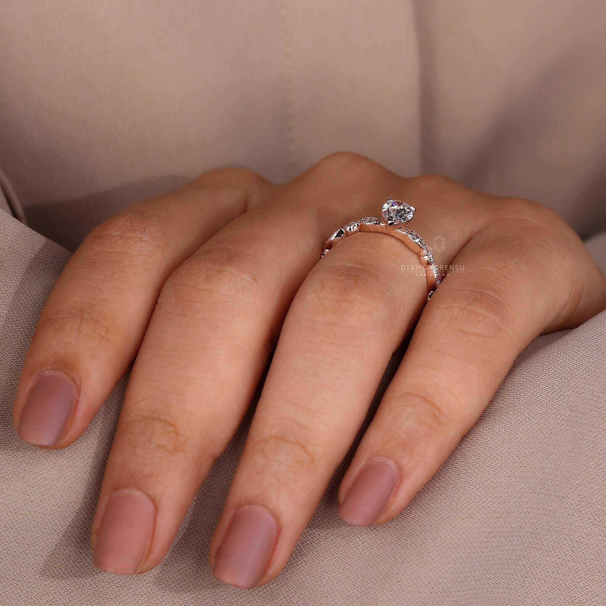 Marquise style wedding band paired with a pear ring and round diamond engagement ring.