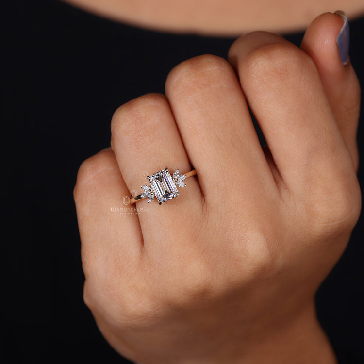 Marquise cut side diamond with emerald center.