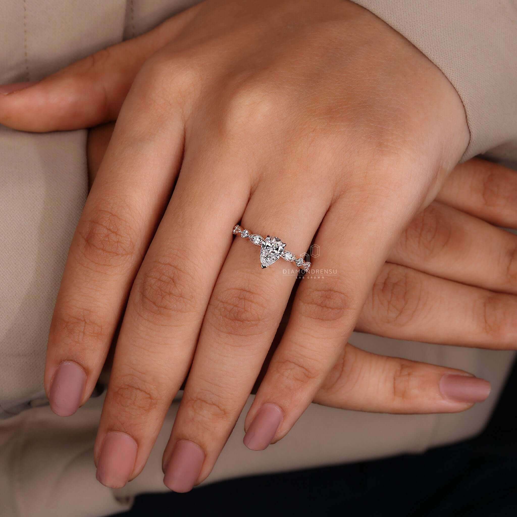 Pear shaped ring diamond featuring a marquise style ring in a modern and elegant design.