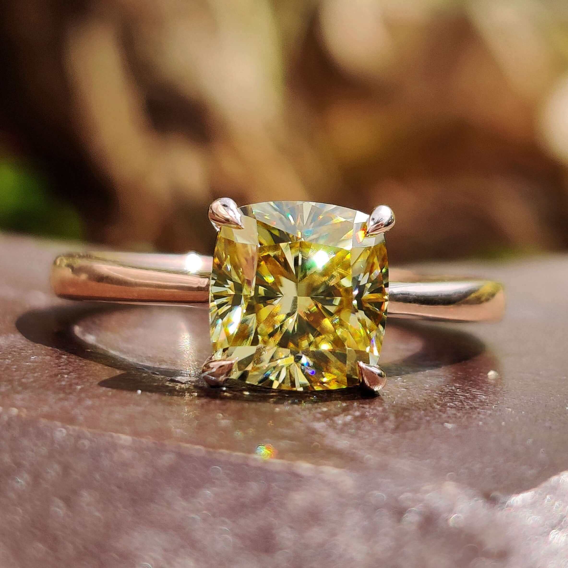 Cushion cut solitaire ring with canary yellow moissanite.