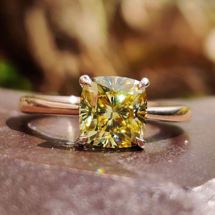 Cushion cut solitaire ring with canary yellow moissanite.