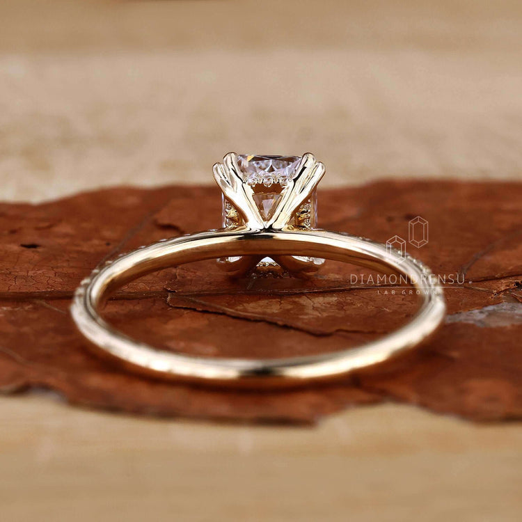 Radiant cut engagement ring with pave diamond ring detailing.