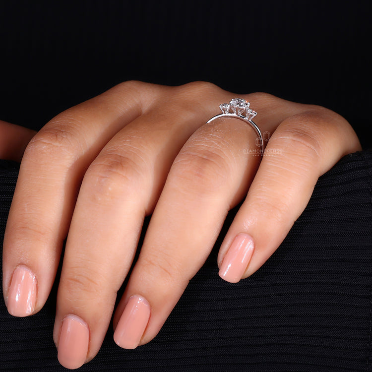 Round cut diamond 3 stone engagement ring.
