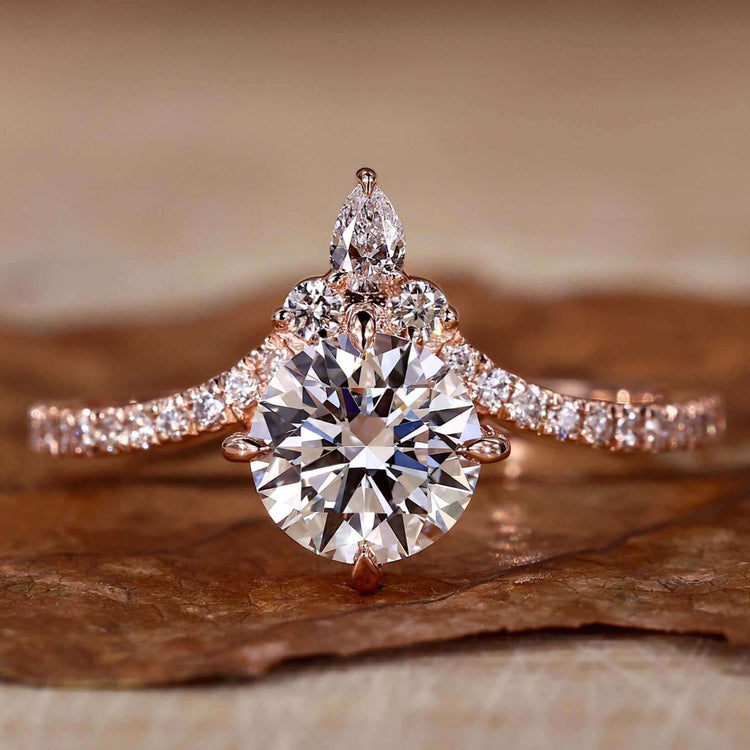 Pear shaped diamond ring with pave detailing and a stunning rose gold setting.