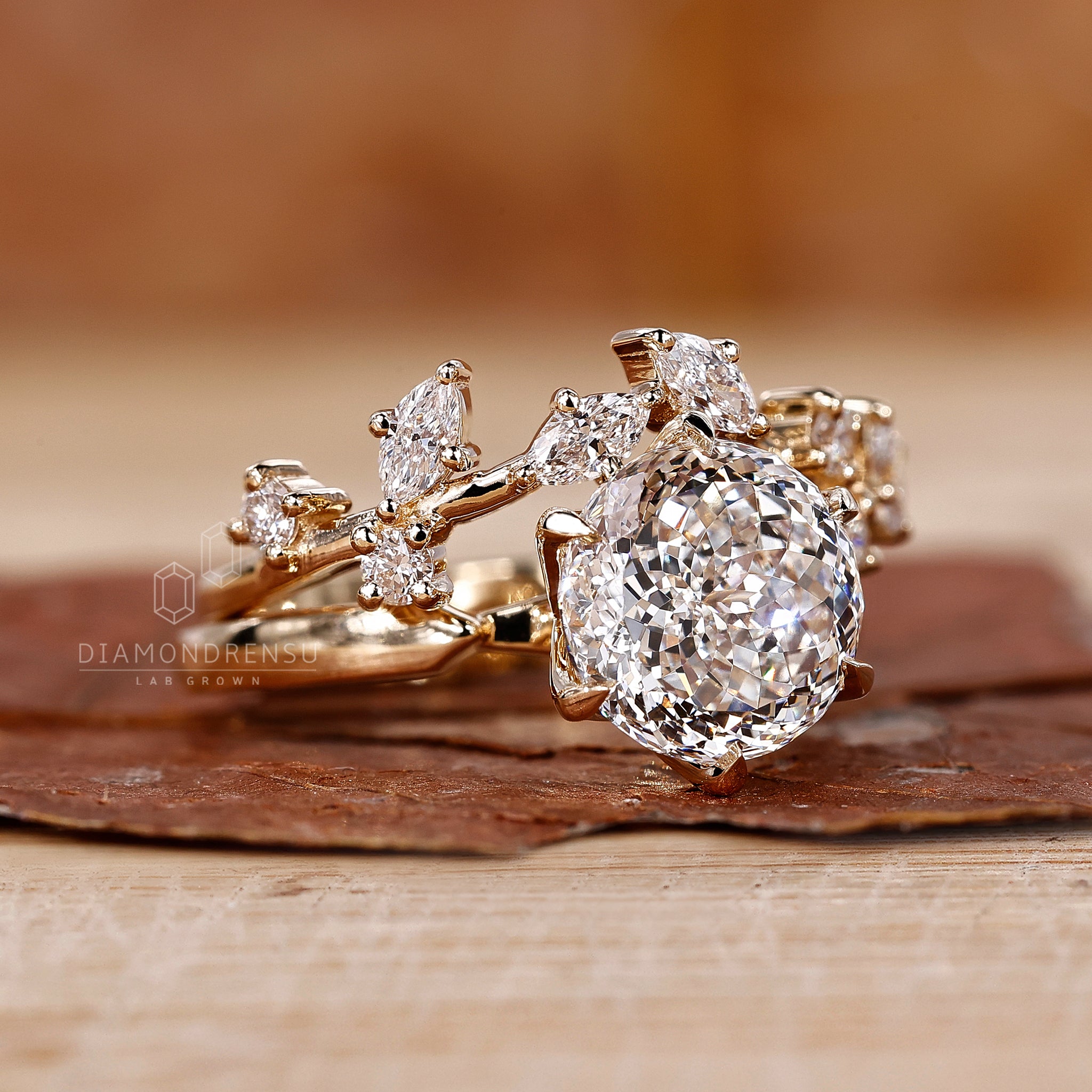 Yellow gold bridal set featuring a leaf style band with marquise and round diamonds.