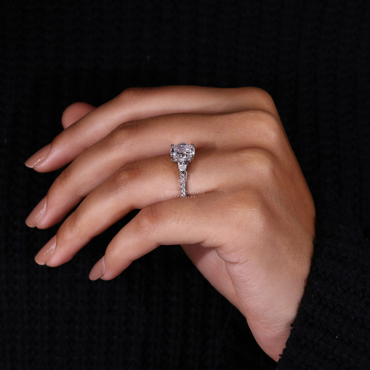 Pear diamond ring with round engagement ring design