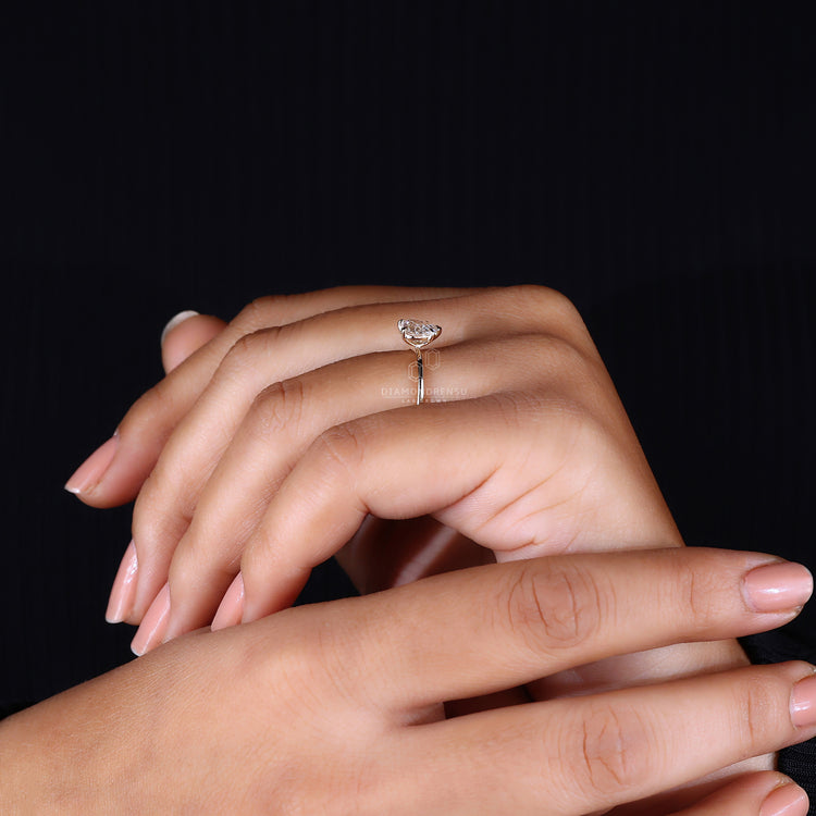 Solitaire setting heart diamond engagement ring.