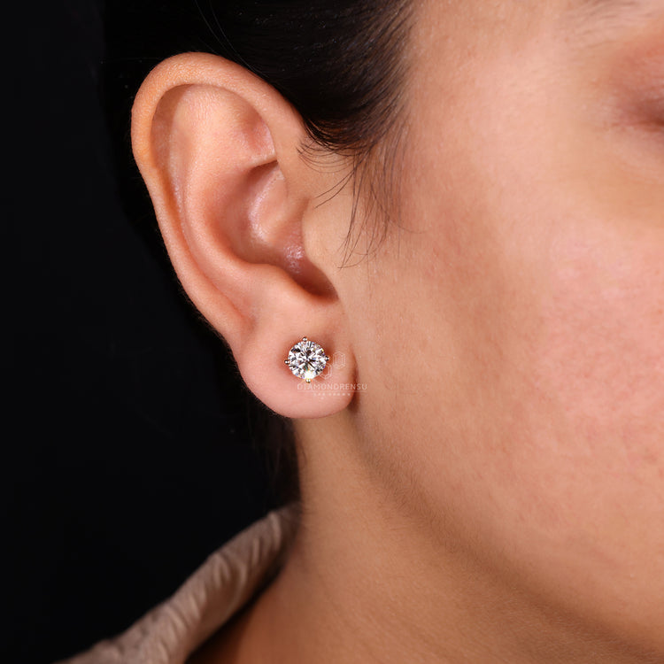 Round cut diamond stud earrings.