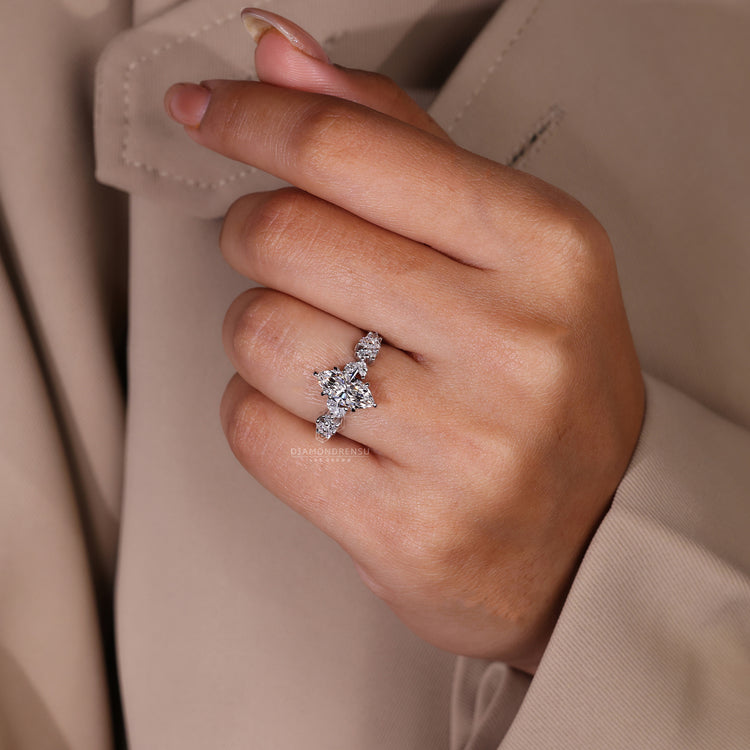 Marquise and round side diamond ring in six claw prong set.