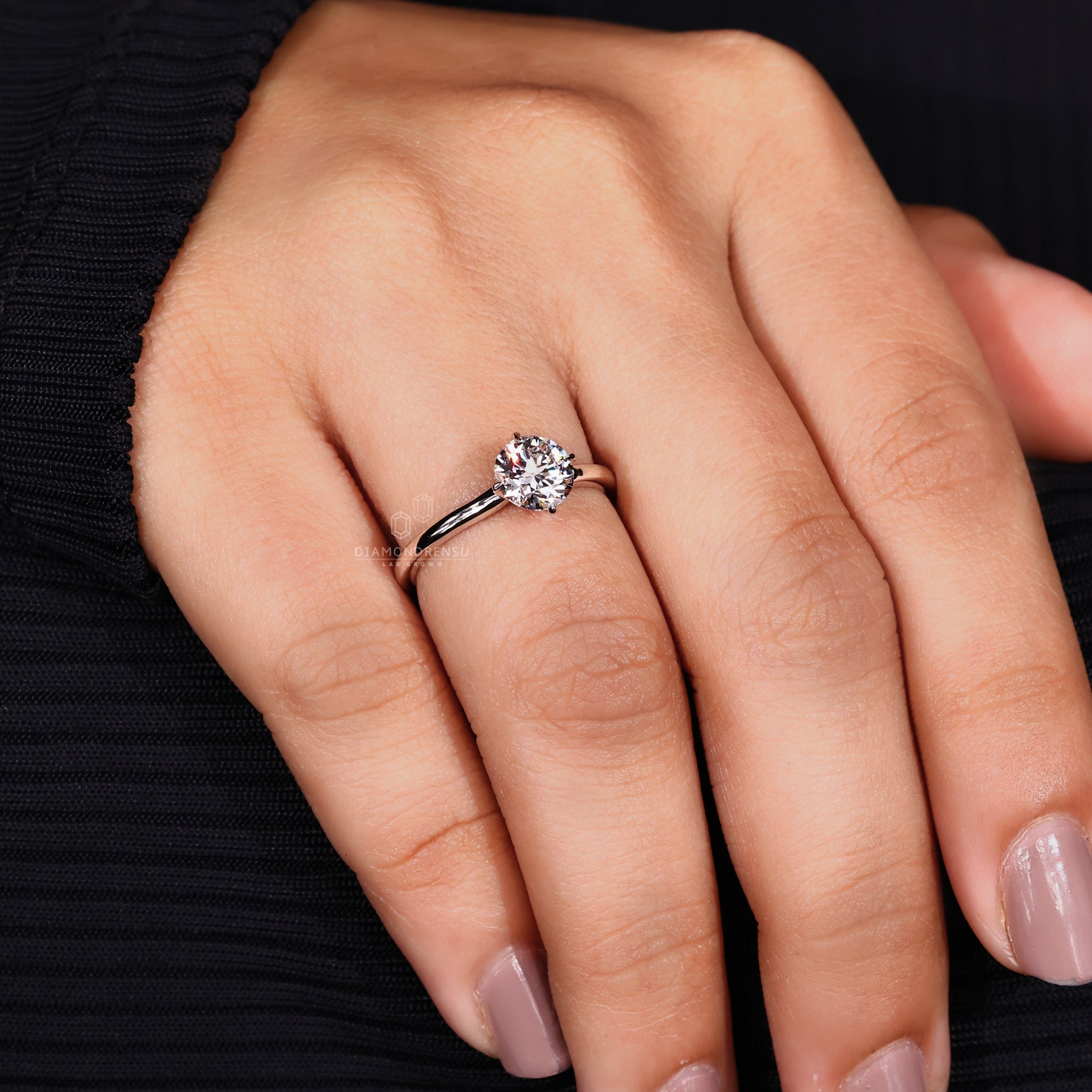 Compass prong setting on round cut solitaire ring.