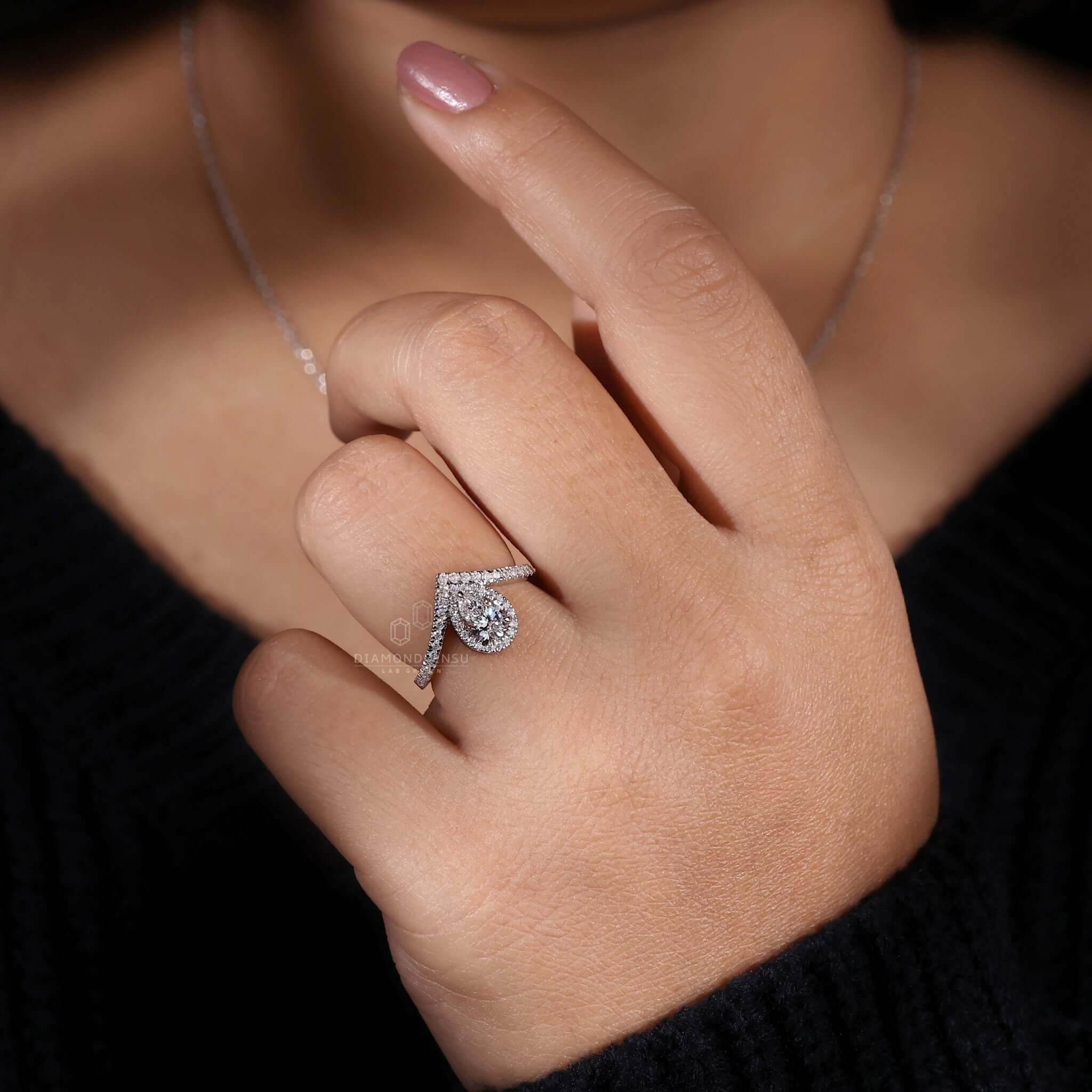 Halo ring setting showcasing a pear cut diamond, ideal for an elegant engagement ring for women.