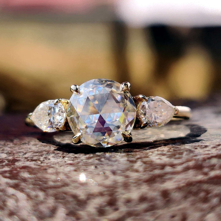Round rose cut moissanite engagement ring in yellow gold.