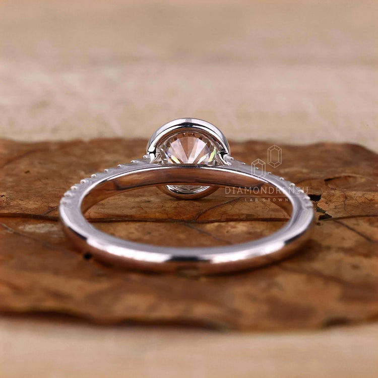 Bezel ring with a round cut diamond, a stunning choice for women who want a unique engagement ring design.