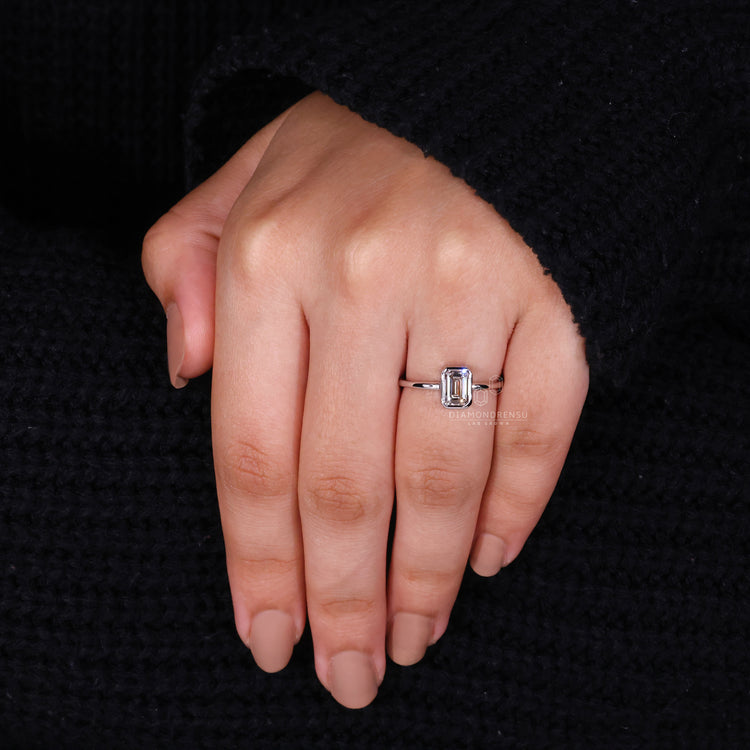 Elegant bezel set diamond ring with a sleek profile.
