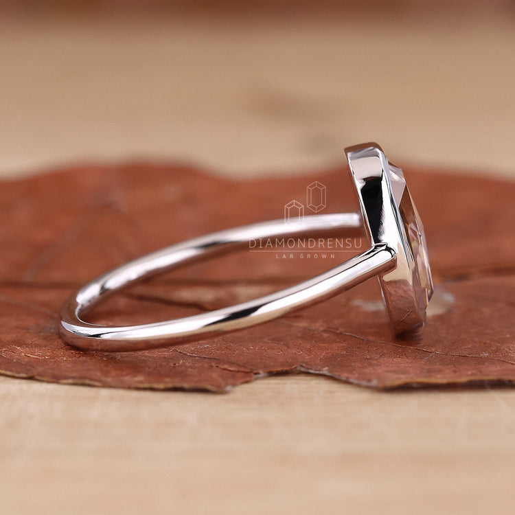 Handmade elongated cushion ring with intricate craftsmanship.