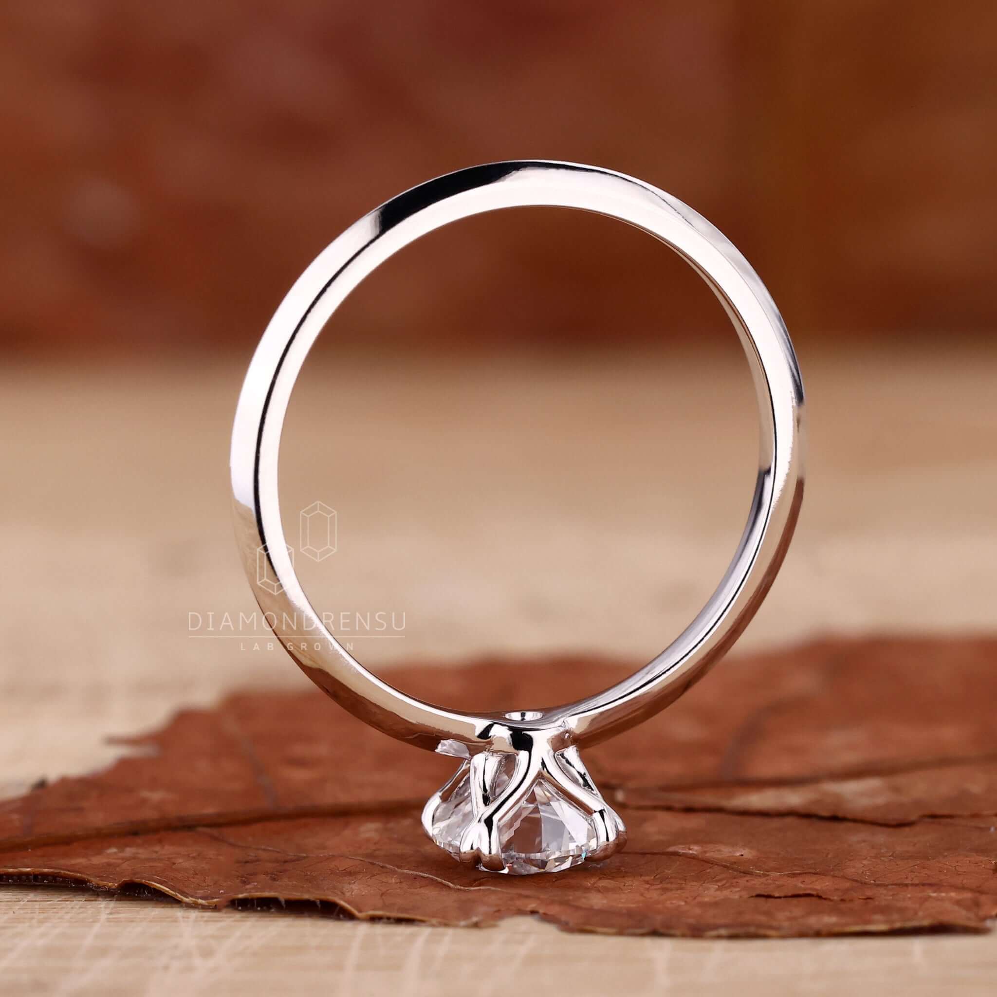 Round cut diamond ring in a classic 4 prong claw setting, perfect for special occasions.