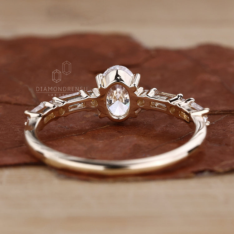 Baguette cut side diamond with oval center.