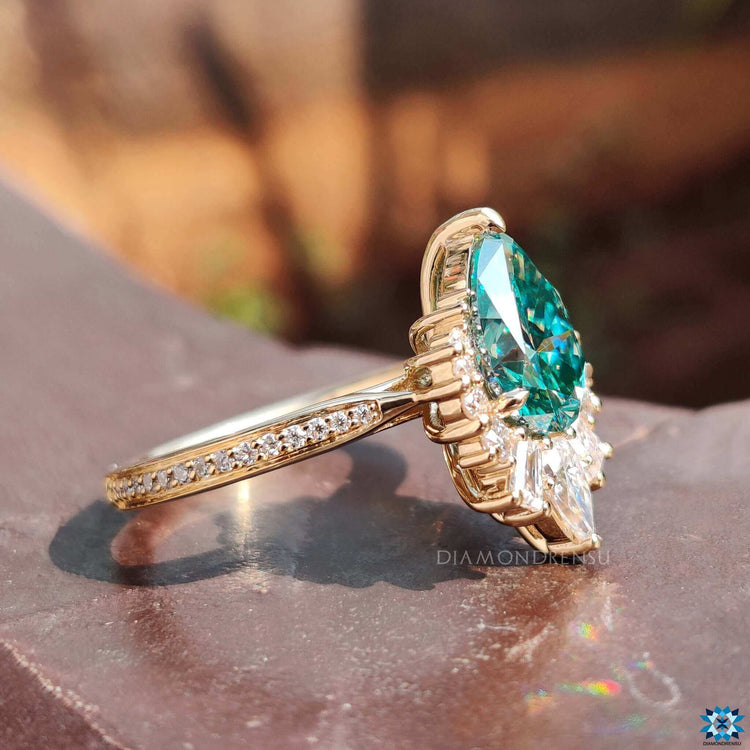 Handmade pear cut moissanite ring with tapered pave band.