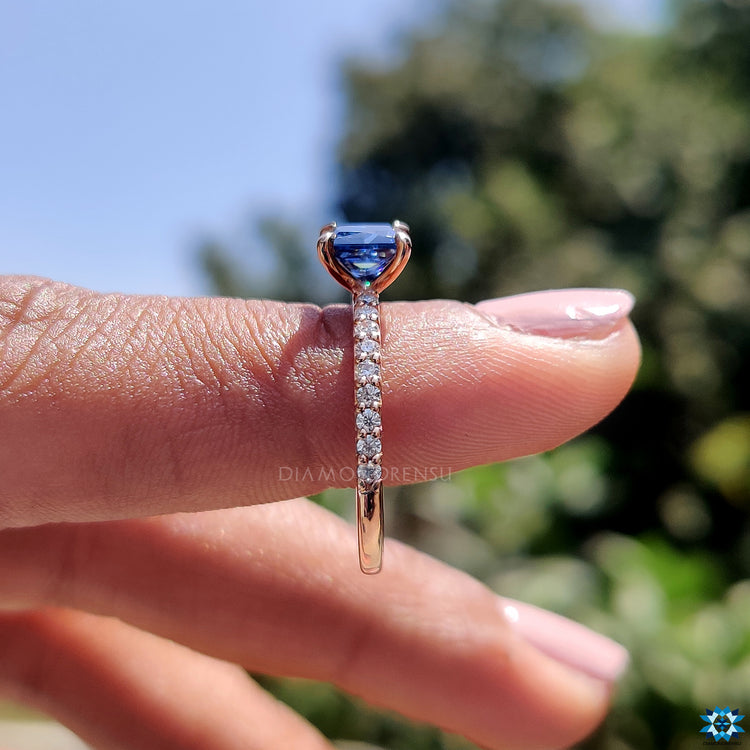 Princess cut moissanite engagement ring in rose gold with handcrafted pave band.