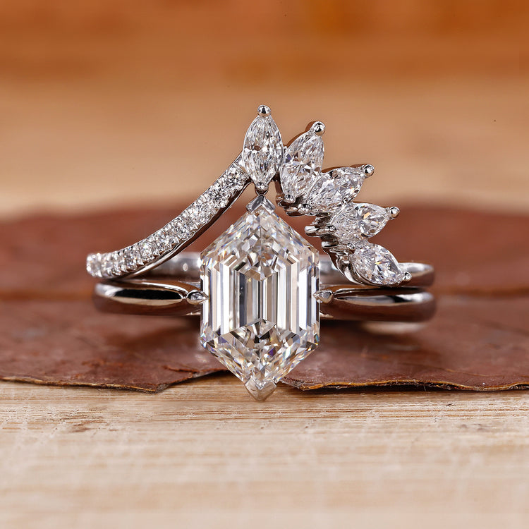 Curved wedding band paired with a solitaire engagement ring in white gold.