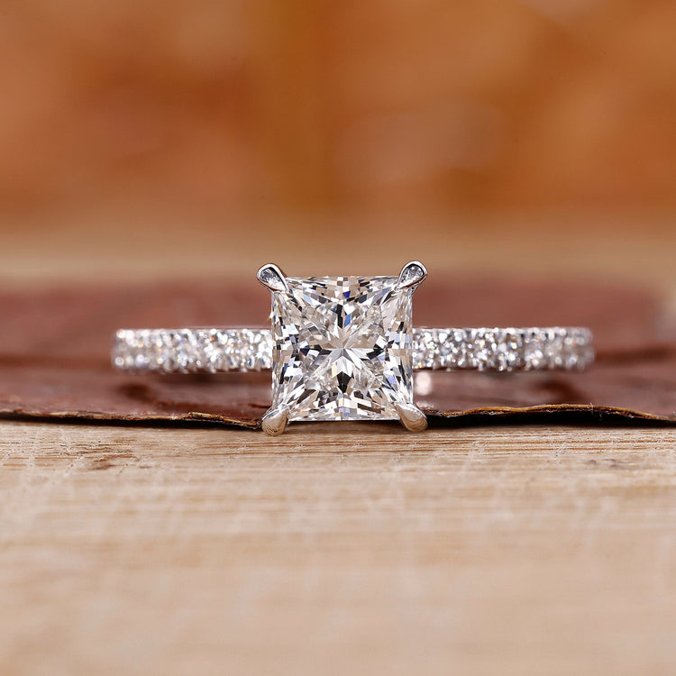 Princess cut diamond engagement ring with pave setting.