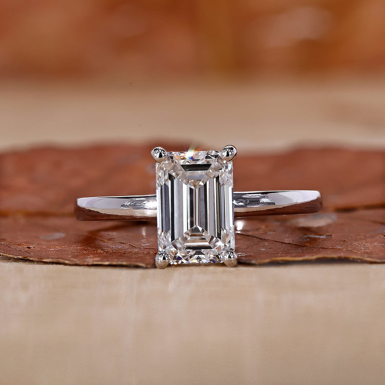 Emerald cut engagement ring with a hidden halo design.