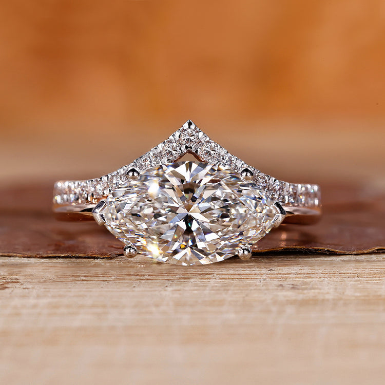 V shaped ring with marquise diamond and hidden halo design.