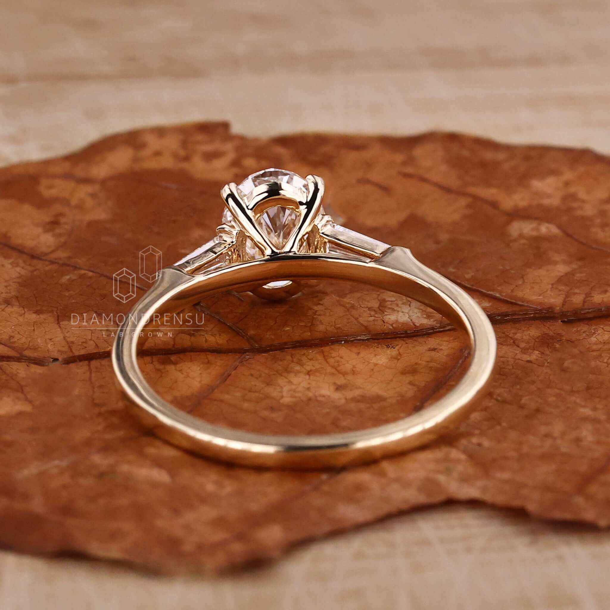 Oval shaped diamond ring in gold with prong claw setting, designed as a unique engagement ring for women.