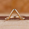 Chevron wedding band crafted in yellow gold with a modern curved shape.