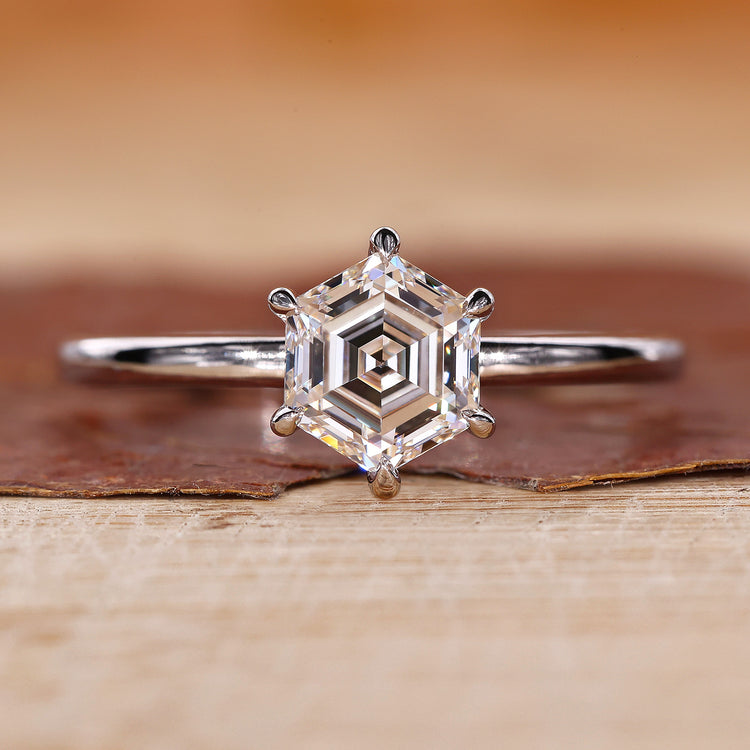 Hexagon step cut diamond shines in the ring.