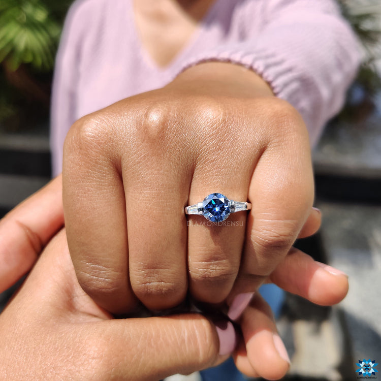 Blue moissanite for engagement ring with secure prong and side detail.
