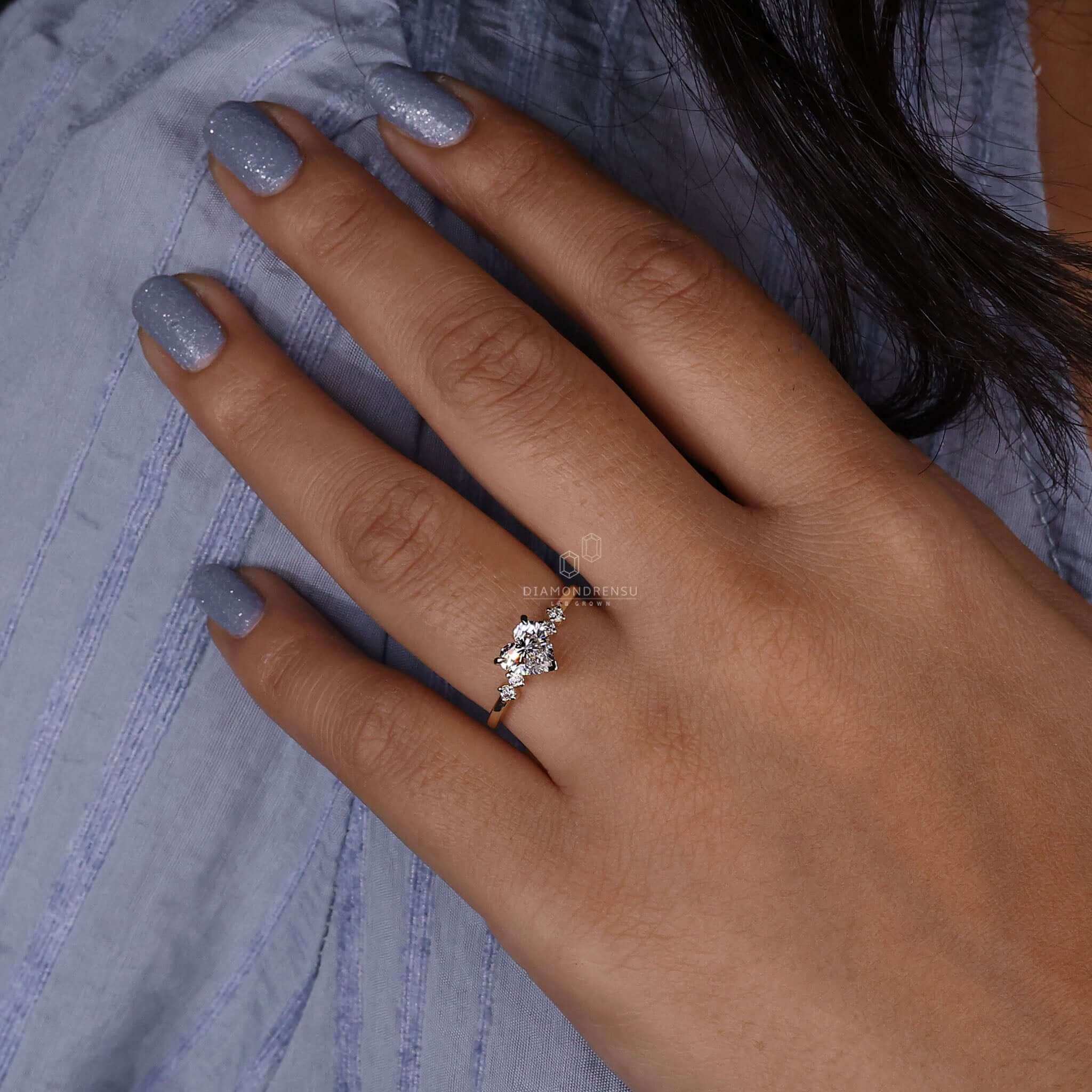 Round diamond ring with side stones, handmade in the UK with IGI certified diamonds.