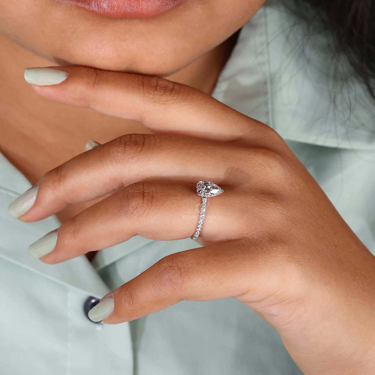 Unique pear engagement ring featuring hidden halo design.