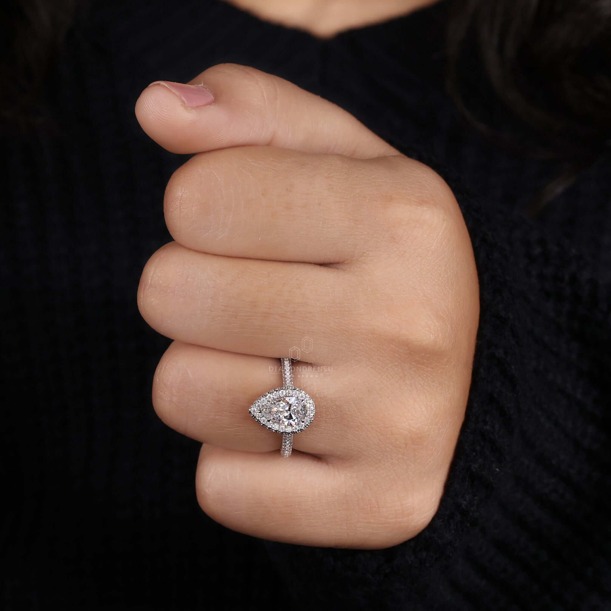 Pear cut engagement ring with a pave diamond setting for exceptional sparkle and beauty.