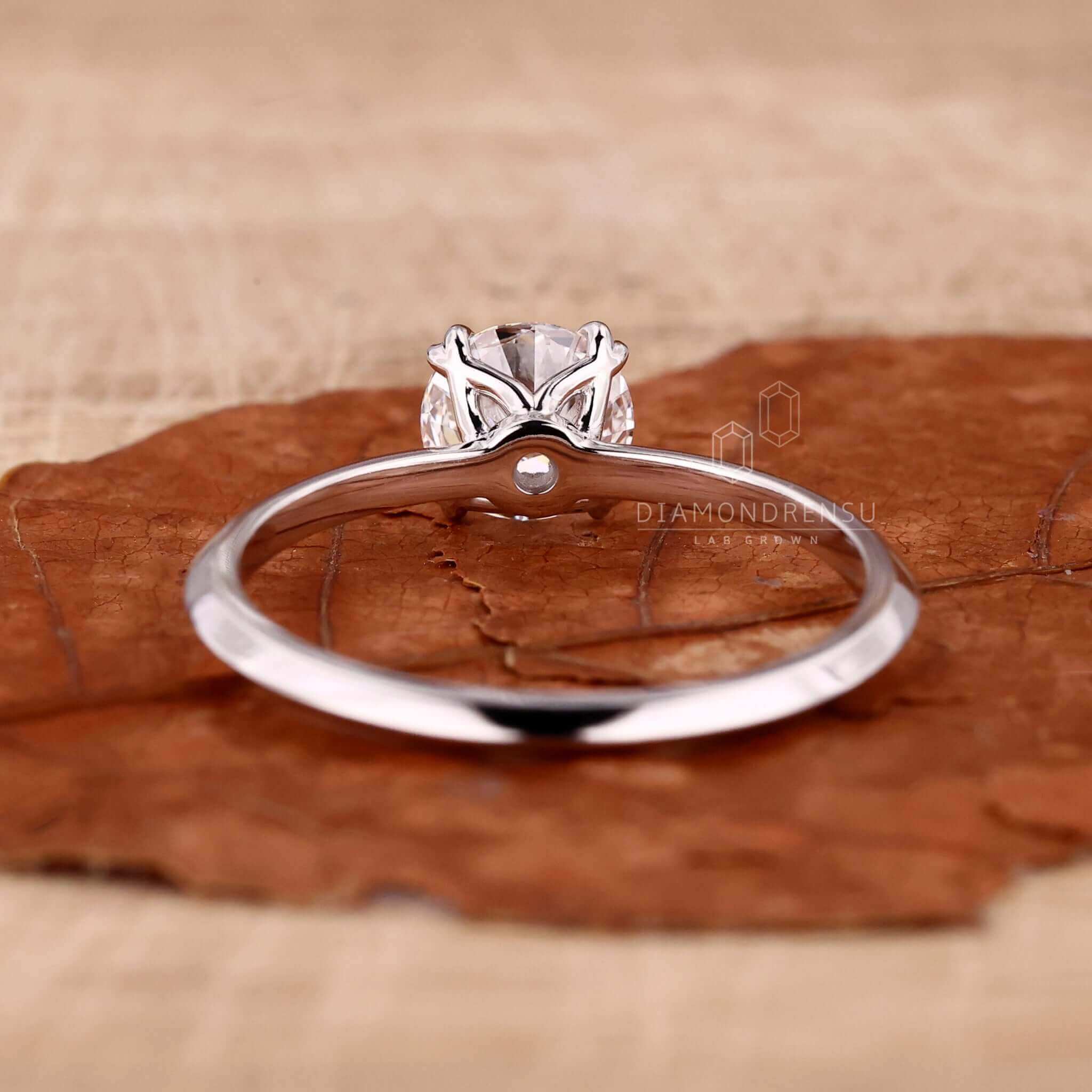 Knife edge ring featuring a 2 carat round diamond and crafted as a bespoke handmade ring.