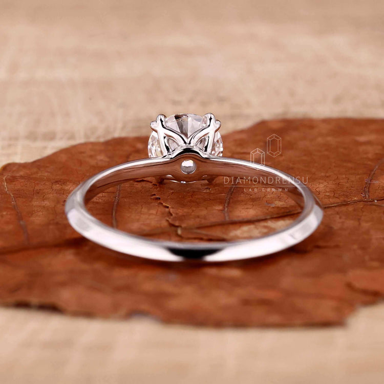 Knife edge ring featuring a 2 carat round diamond and crafted as a bespoke handmade ring.