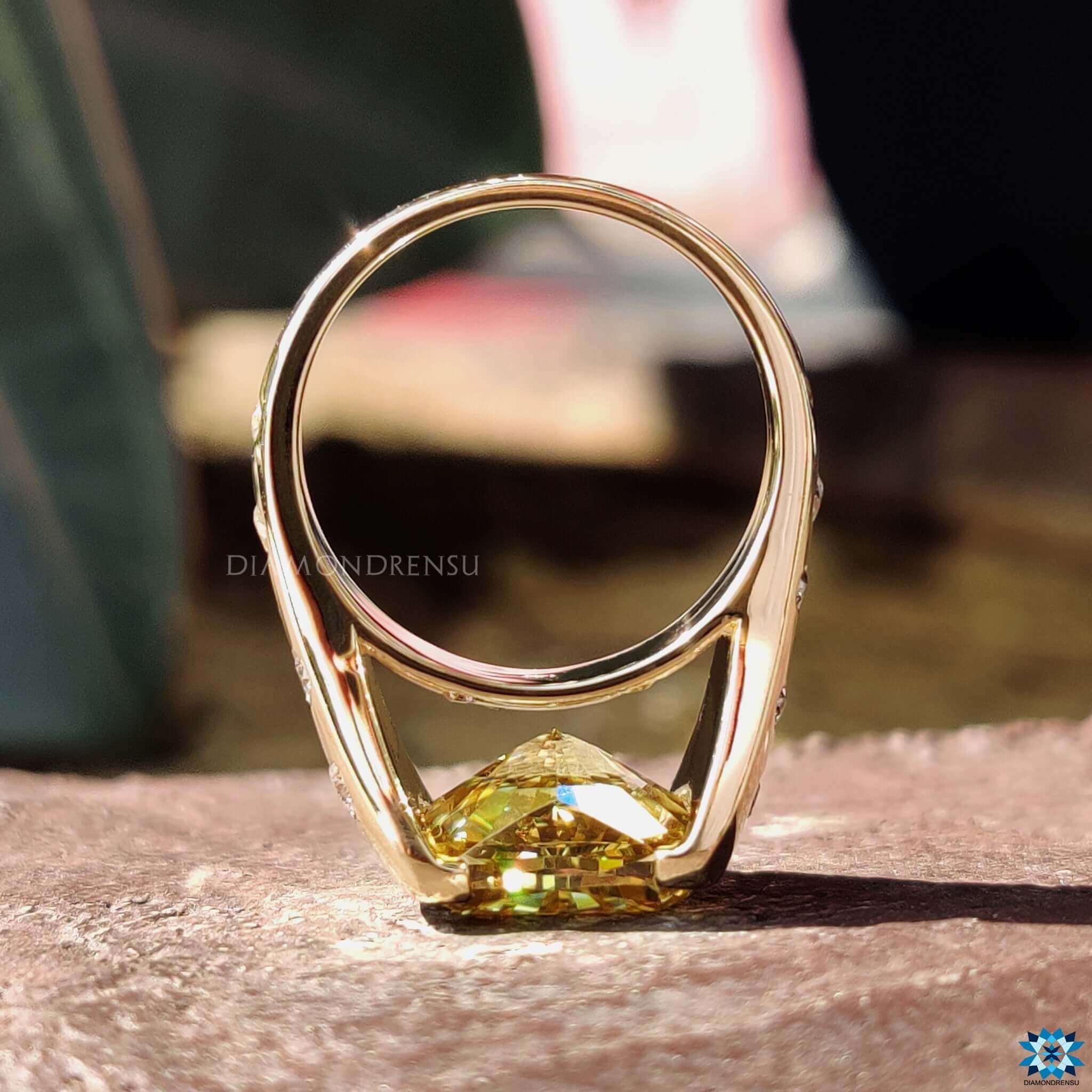 Custom engagement ring with yellow cushion cut moissanite centerpiece.