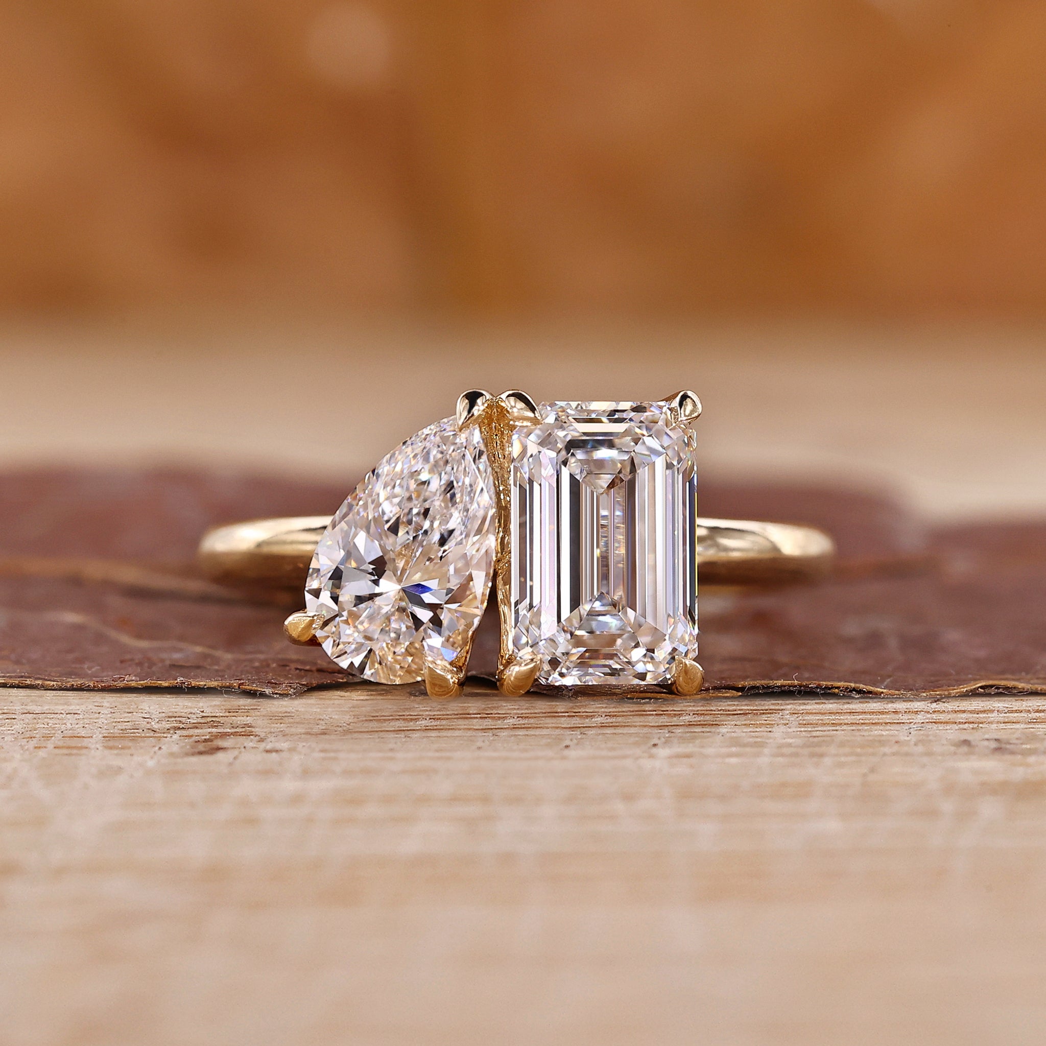 Toi et Moi engagement ring with emerald and pear cut diamonds