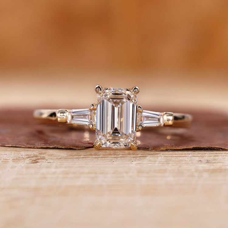 3 stone emerald cut diamond ring in yellow gold, made for UK engagement ring buyers.