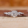 Portuguese diamond engagement ring with round side diamond in white gold.
